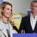 Governor Gavin Newsom looks on as his wife Jennifer Siebel Newsom speaks.