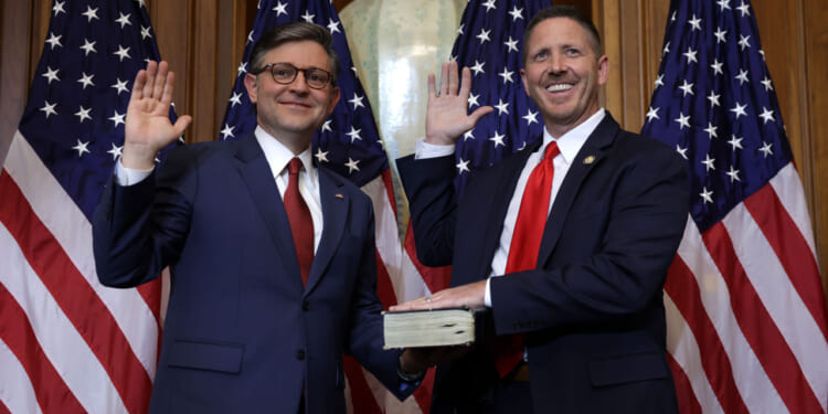 U.S. Speaker of the House Rep. Mike Johnson (R-LA) (L) participates in a ceremonial swearing-in with Rep. Josh Brecheen (R-OK) at the U.S. Capitol on January 3, 2025 in Washington, DC.