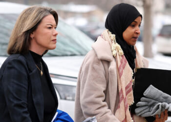 Ilhan Omar (D-MN) (R) and Angie Craig (D-MN) walk to the Bishop Henry Whipple Federal building.