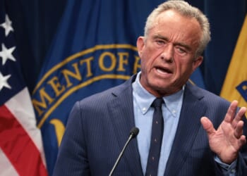 Robert F. Kennedy Jr. speaking while holding up his hand