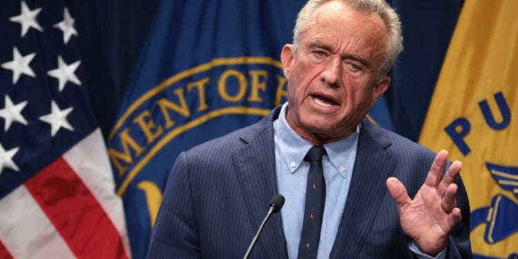 Robert F. Kennedy Jr. speaking while holding up his hand