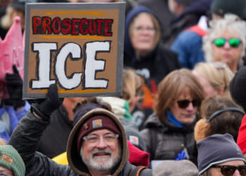 A protester holds a sign reading "Prosecute ICE" during a "No Kings" rally at the Minnesota State Capitol in St. Paul on Saturday, March 28, 2026. (Jerry Holt/The Minnesota Star Tribune/Getty Images)