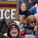 A protester holds a sign reading "Prosecute ICE" during a "No Kings" rally at the Minnesota State Capitol in St. Paul on Saturday, March 28, 2026. (Jerry Holt/The Minnesota Star Tribune/Getty Images)