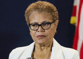 Karen Bass stands with a straight face.