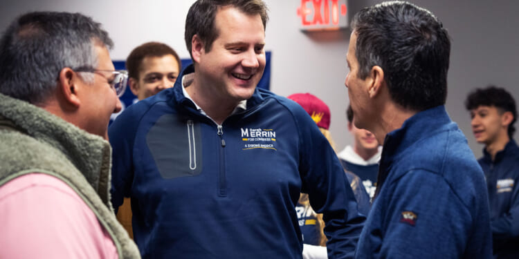 Republican Derek Merrin smiles as he talks with Bernie Moreno and Alex Triantafilou.
