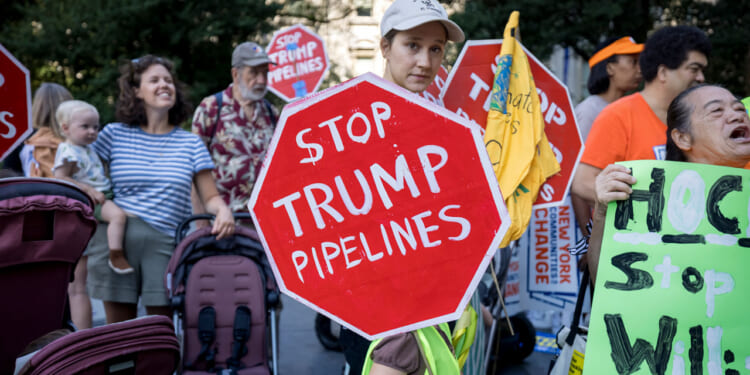 Climate activists march across the Brooklyn Bridge to demand that New York Governor Kathy Hochul stop the construction of the Williams Pipeline. Protests against this pipeline have previously shut down the pipeline that supplies fracked gas. (Photo by Michael Nigro/Pacific Press/LightRocket via Getty Images)