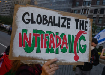 Sign reading "Globalize the Intifada"