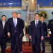 U.S. President Donald Trump walks to his motorcade as he is greeted by Chinese officials at Beijing Capital International Airport.
