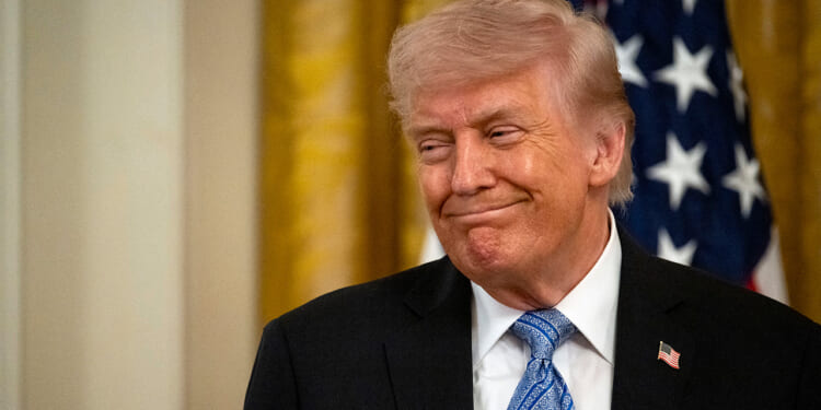 Trump smiles.