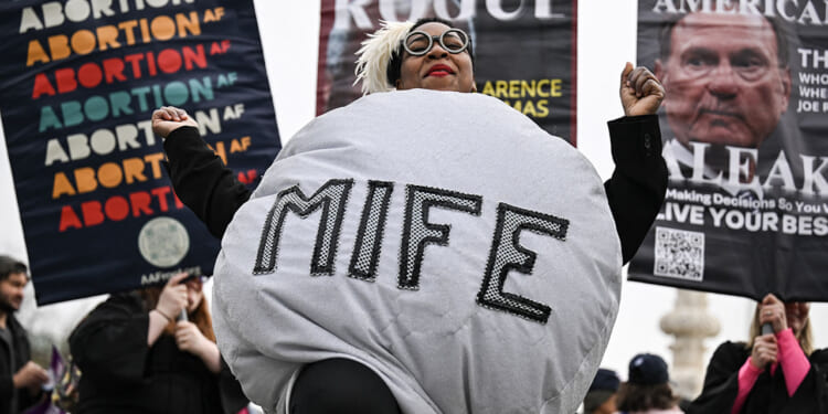 A woman dressed as a mifepristone pill dances with supporters of Planned Parenthood and pro-choice activists during a rally outside the US Supreme Court on April 2, 2025, in Washington, DC. (DREW ANGERER/AFP/Getty Images)