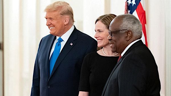 President Donald J. Trump poses for a photo with Supreme Court Associate Justices Amy Coney Barrett and Clarence Thomas in the Cross Hall of the White House Monday, Oct. 26, 2020, after attending Barrett's swearing-in ceremony as Supreme Court associate justice. (Official White House photo by Andrea Hanks)