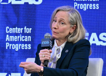 A seated Abigail Spanberger makes a point while speaking at a gathering for the Center for American Progress.