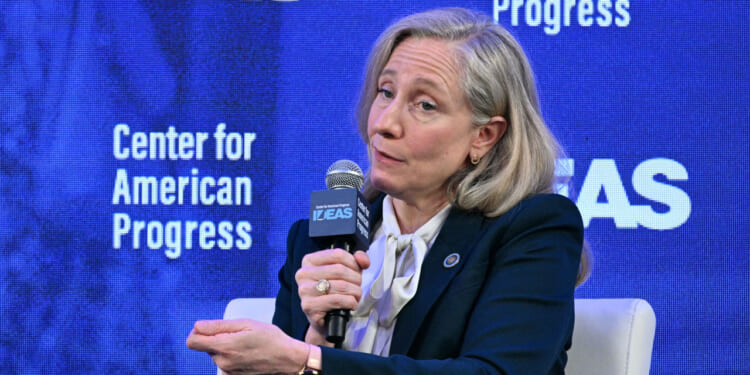 A seated Abigail Spanberger makes a point while speaking at a gathering for the Center for American Progress.