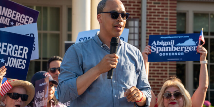 Jay Jones in blue shirt and sunglasses speaks at a 2025 campaign event.