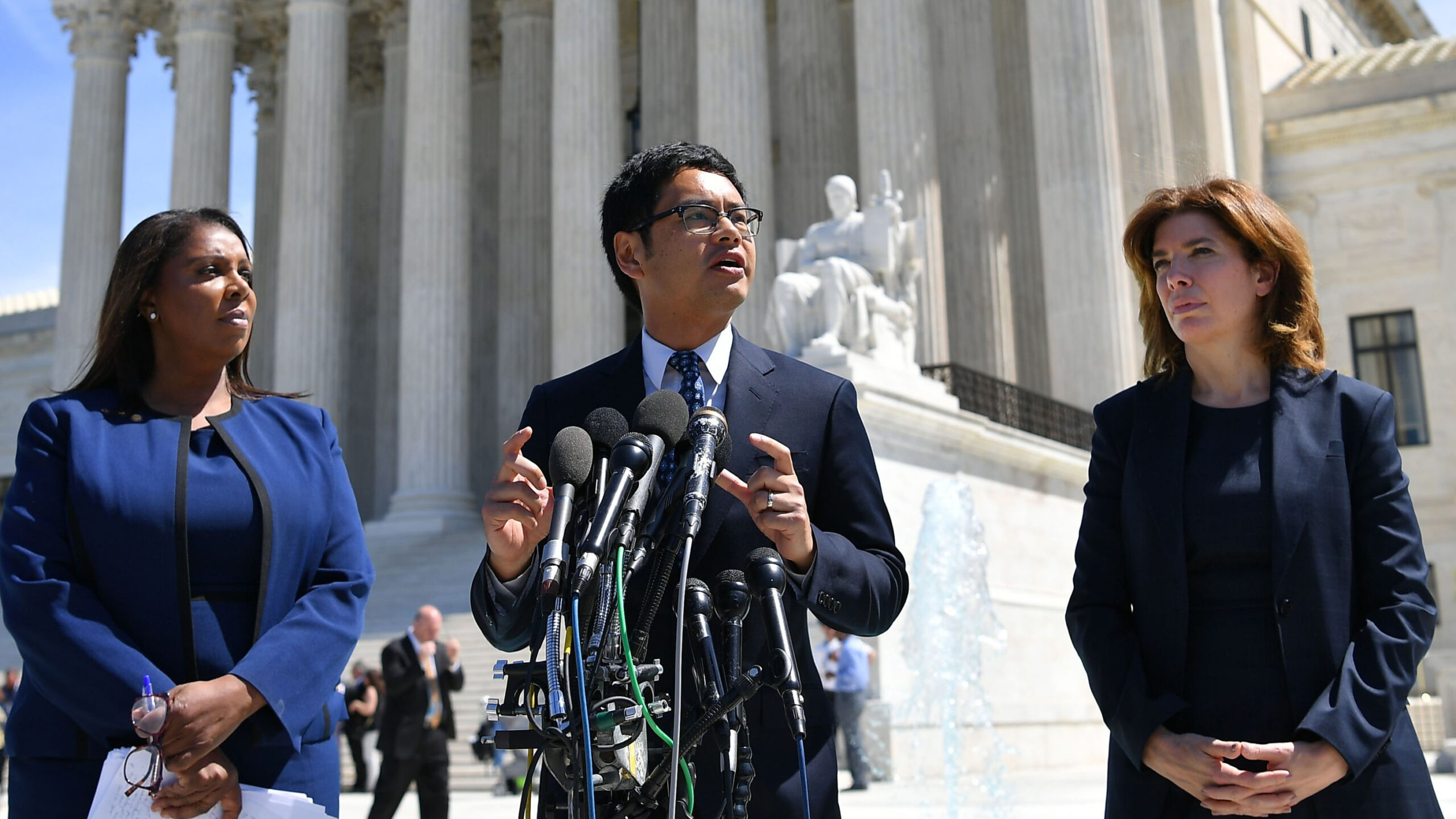 Then-ACLU's Voting Rights Project Director Dale Ho (C) flanked by New York Attorney General Letitia James (L) and Director of the Census for New York City Julie Menin (R) speaks to reporters outside of the US Supreme Court in Washington, DC on April 23, 2019. - In March 2018, US Secretary of Commerce Wilbur Ross announced he was going to reintroduce for the 2020 census a question on citizenship abandoned more than 60 years ago. The decision sparked an uproar among Democrats and defenders of migrants -- who have come under repeated attack from an administration that has made clamping down on illegal migration a hallmark as President Donald Trump seeks re-election in 2020. (Photo by MANDEL NGAN / AFP) (Photo credit should read MANDEL NGAN/AFP via Getty Images)
