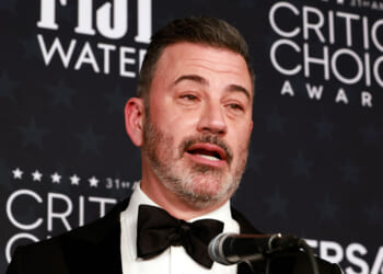 Close-up of Jimmy Kimmel speaking into a microphone at the Critics Choice Awards.