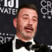 Close-up of Jimmy Kimmel speaking into a microphone at the Critics Choice Awards.