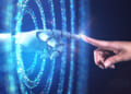 Graphic showing a robotic AI-driven hand reaching through rings of blue light to touch forefingers with a human hand.