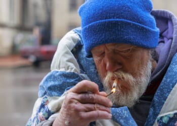 A man lighting a cigarette