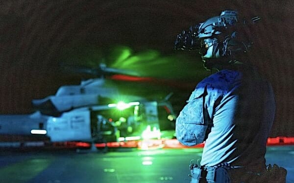 A Marine assigned to the Maritime Raid Force, 11th Marine Expeditionary Unit, observes the flight deck during fast-rope training aboard the amphibious assault ship USS Boxer in the South China Sea, Thursday, June 4, 2026. (U.S. Marine Corps photo by Sgt. Trent A. Henry)
