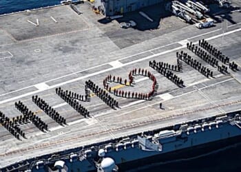 Sailors aboard the Nimitz-class aircraft carrier USS Carl Vinson spell out 'Hi Mom!!' on the flight deck of the ship in celebration of Mother's Day 2021. (U.S. Navy photo by Mass Communication Specialist 3rd Class Christina Ross)