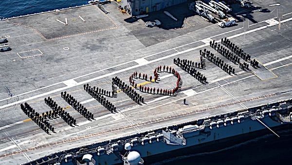Sailors aboard the Nimitz-class aircraft carrier USS Carl Vinson spell out 'Hi Mom!!' on the flight deck of the ship in celebration of Mother's Day 2021. (U.S. Navy photo by Mass Communication Specialist 3rd Class Christina Ross)