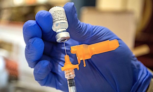 An Air Force medical technician draws a dose of the COVID-19 vaccine to inoculate Air Force reservists at Joint Base Lewis McChord, Washington, Sept. 12, 2021. (U.S. Air Force photo by Staff Sgt. Paolo Felicitas)