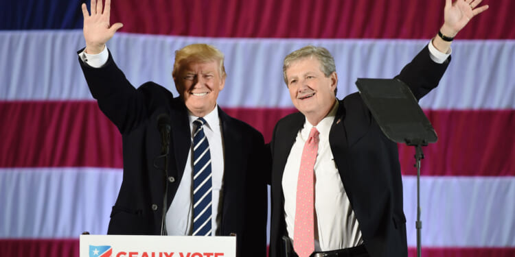 Donald Trump stands beside Louisiana Treasurer and Republican Senate candidate John Kennedy.