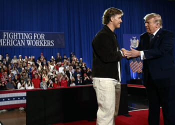US President Donald Trump is welcomed by New York Giants quarterback Jaxson Dart before delivering a speech about the economy at Rockland Community College Fieldhouse in Suffern, New York, on May 22, 2026.