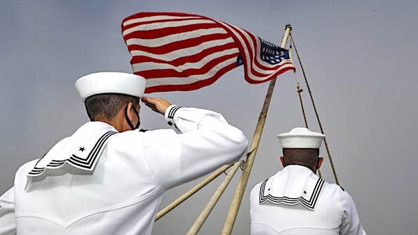 Aviation Ordnanceman Airman Angel Ochoa (left), from Chula Vista, California, and Aviation Ordnanceman 3rd Class Rodney Himes, from Hampton, Virginia, shift colors on the flight deck of the aircraft carrier USS Abraham Lincoln in the Pacific Ocean, August 3, 2021. (U.S. Navy photo by Mass Communication Specialist 3rd Class Jeremiah Bartelt)