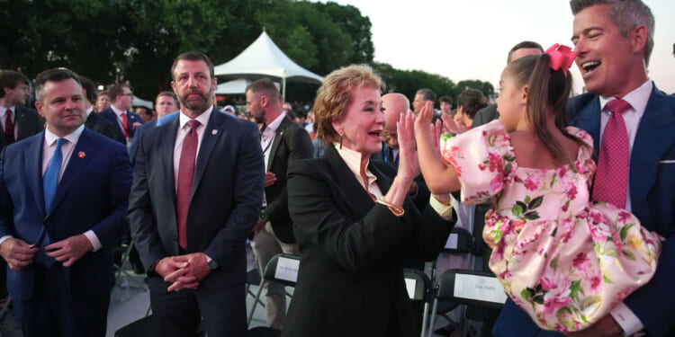 Secretary of Education Linda McMahon plays with a child of U.S. Secretary of Transportation Sean Duffy.
