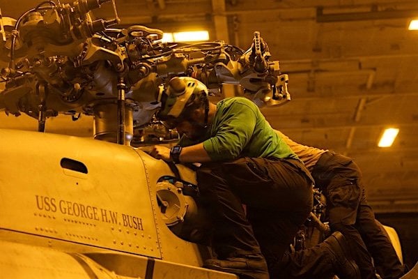 U.S. Sailors maintain an MH-60S Sea Hawk helicopter aboard USS George H.W. Bush (CVN 77) in the Arabian Sea in this photo released on Tuesday, June 30, 2026 (CENTCOM photo)
