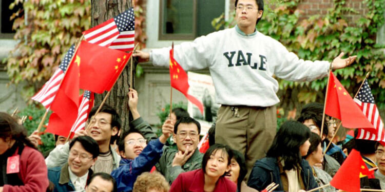 Several thousand people fill the streets around Harvard University for the visit of then Communist Chinese President Jiang Zemin before he spoke on campus 01 November, in Cambridge, MA. Zemin is on a six-city, eight-day tour of the US.