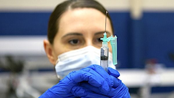 Connecticut Army National Guard Sgt. 1st Class Sara Landon prepares COVID-19 vaccine doses April 1, 2021, in Morton Hall Gymnasium at Naval Submarine Base New London in Groton, Connecticut. (U.S. Navy photo by Mass Communication Specialist 2nd Class Tristan B. Lotz)