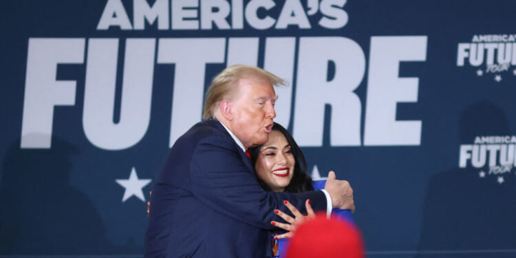 Donald Trump, with candidate for US Representative Mayra Flores (R), departs after a roundtable with Latino leaders at Beauty Society Inc., in North Las Vegas.