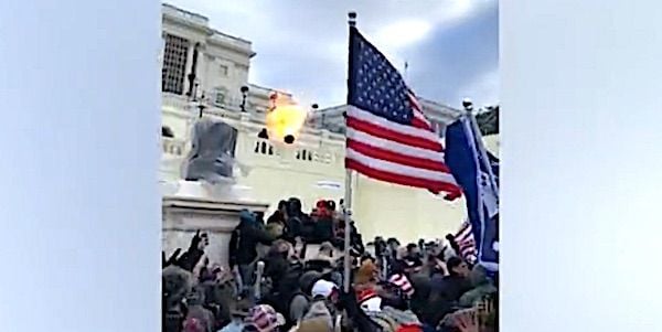 Police fire at protesters outside the U.S. Capitol on Jan. 6, 2021. (Video screenshot)