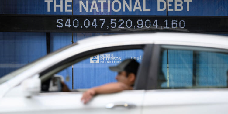 An electronic display shows the national debt in Washington, DC on August 19, 2026. The US national debt exceeded a record 40 trillion USD. The US gross national debt has surged past $40 trillion for the first time, government data showed Wednesday, outstripping earlier forecasts at a pace fuelled in part by President Donald Trump's invalidated tariffs. The uptick in borrowing comes as longer term US obligations linked to social security and health care have been growing, while interest payments have climbed as well. (Photo by Mandel NGAN / AFP via Getty Images)