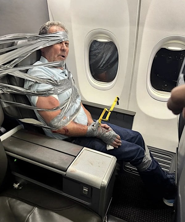 A passenger idenitified as Arthur Layne Lundeen is duct-taped aboard American Airlines flight 618 on Thursday, Sept. 3, 2026 (Courtesy Richard Olenick)