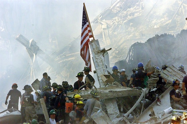 FILE - In this Sept. 13, 2001 file photo, an American flag flies over the rubble of the collapsed World Trade Center buildings in New York. For years, a handful of current and former Am