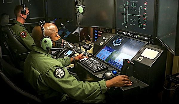 U.S. Marine Corps Captain Joshua Brooks, an unmanned aircraft system representative, and Master Sergeant Willie Cheeseboro Jr., an enlisted aircrew coordinator with Marine Unmanned Aerial Vehicle Squadron 1, prepare to launch and operate the first Marine Corps owned MQ-9A Reaper on Marine Corps Air Station Yuma, Arizona, Aug. 30, 2021. (U.S. Marine Corps photo by Lance Cpl. Gabrielle Sanders)