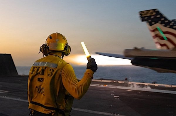 A U.S. Sailor signals as an EA-18G Growler takes off from the flight deck of USS George H.W. Bush (CVN 77) on Thursday, May 7, 2026. Bush is operating with more than 20 U.S. warships enforcing the blockade against Iran. (U.S. Central Command photo)
